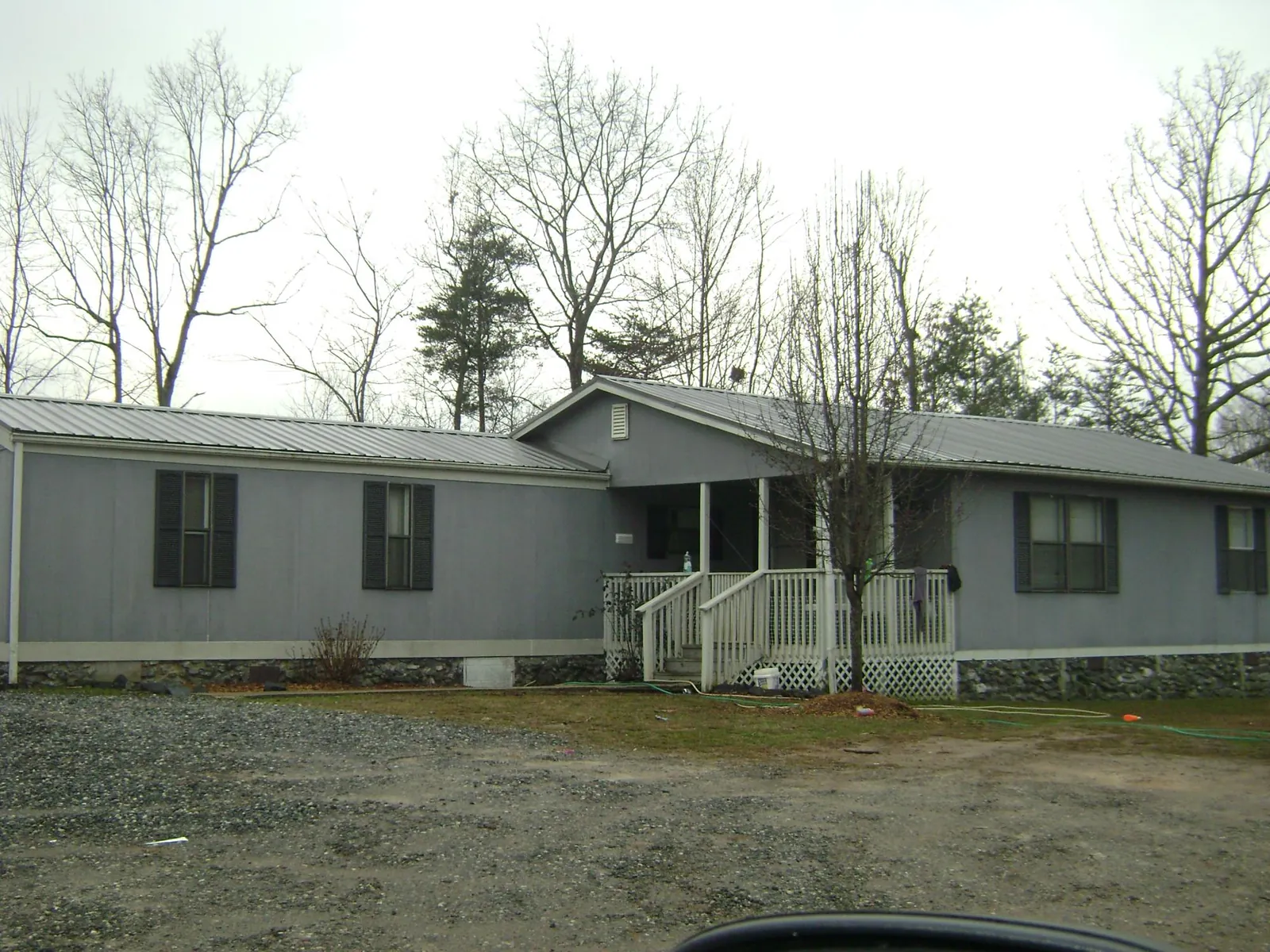 Metal roof over a manufactured home with a covered front porch in Jeffersonville